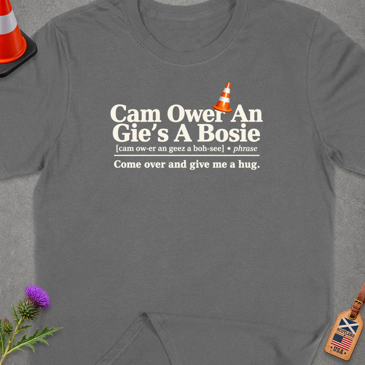 Grey t-shirt with "Cam Ower An Gie's A Bosie" text and a traffic cone.
