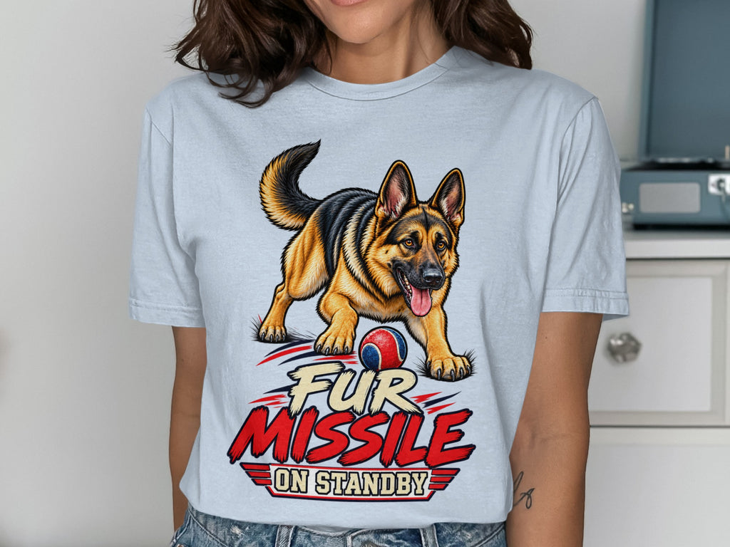 German Shepherd with ball and text "Fur Missile On Standby" on light blue t-shirt.