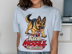 German Shepherd with ball and text "Fur Missile On Standby" on light blue t-shirt.