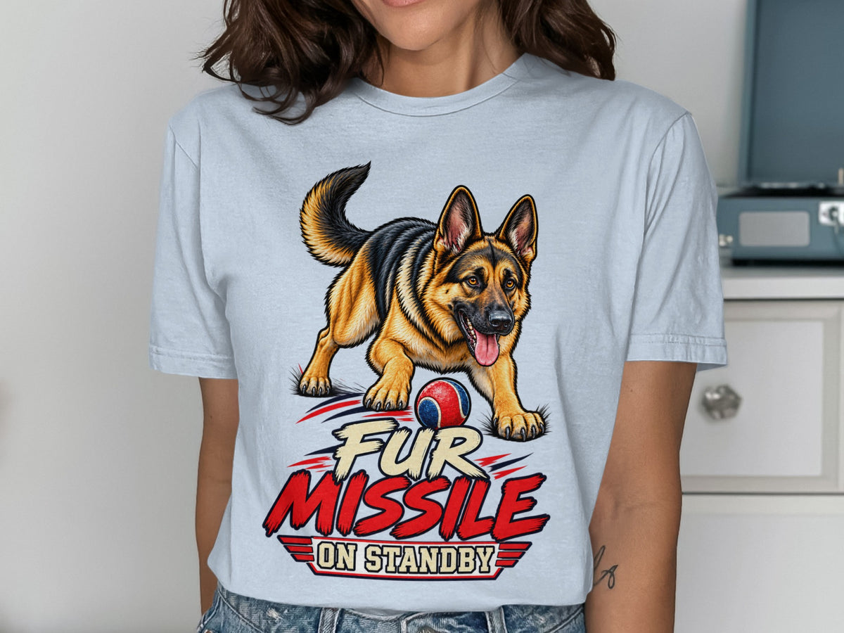 German Shepherd with ball and text "Fur Missile On Standby" on light blue t-shirt.
