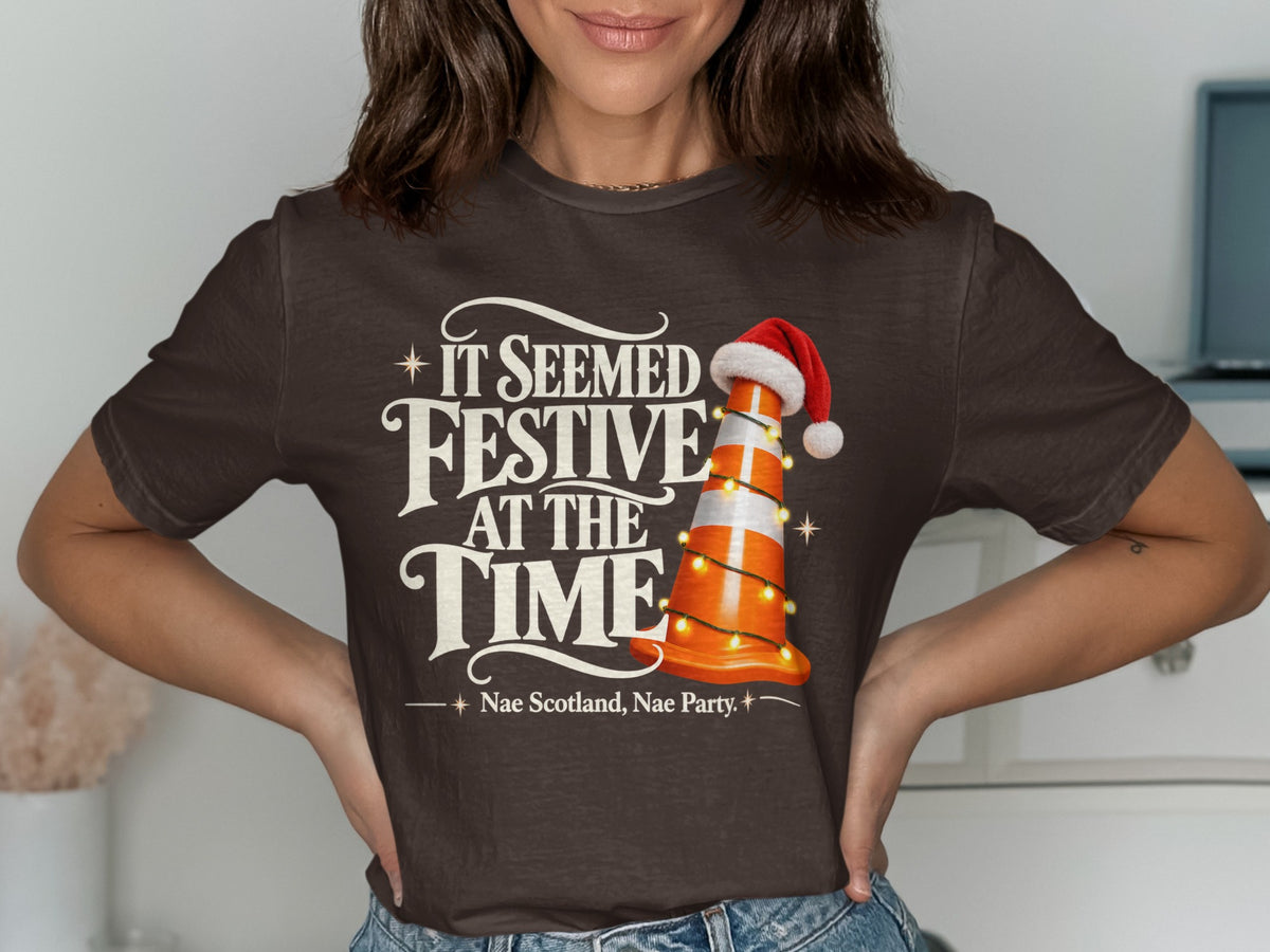 Brown t-shirt with "It Seemed Festive At The Time" and a traffic cone.