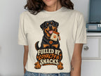 Cream t-shirt with a Rottweiler graphic saying "Fueled by Loyalty & Snacks".