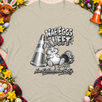 T-shirt graphic with a cartoon bunny, traffic cone, and text "Nae Eggs Left."