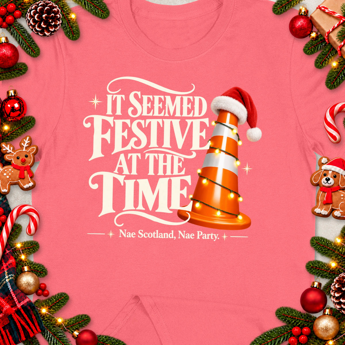 Pink t-shirt with "It Seemed Festive At The Time" and a traffic cone with Santa hat.