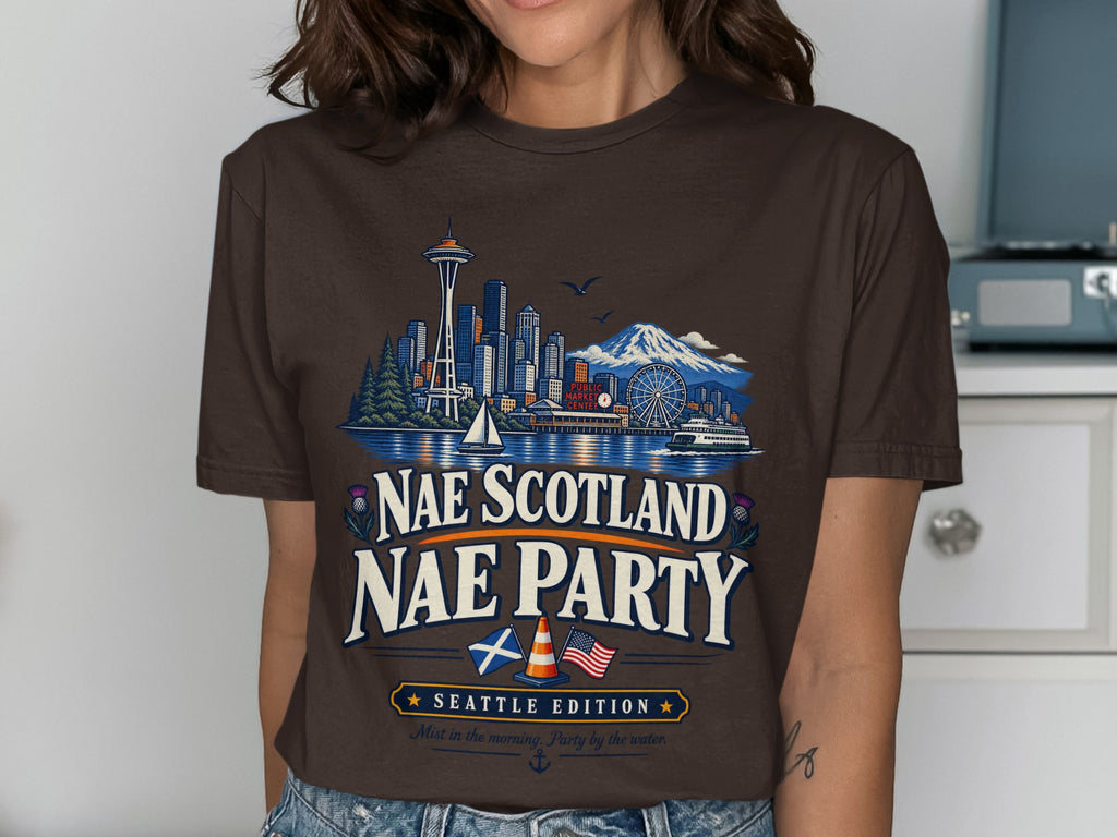 Brown t-shirt with Seattle skyline, mountains, and text "NAE SCOTLAND NAE PARTY SEATTLE EDITION".