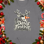 T-shirt with a Christmas-themed graphic of a reindeer wearing sunglasses and a scarf, with text "Deerly Festive Nae Scotland, Nae Party".