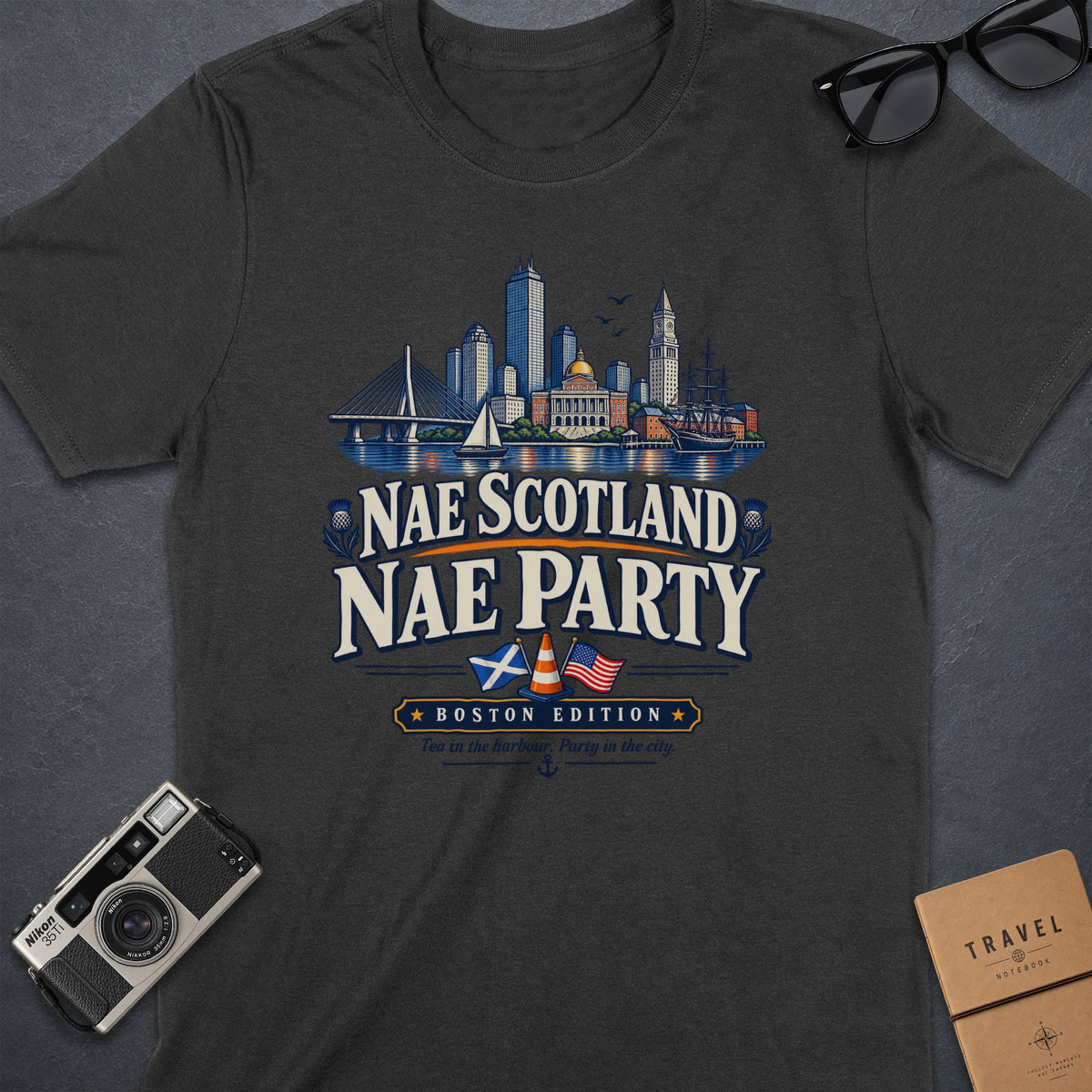 Dark t-shirt with Boston skyline and "Nae Scotland Nae Party Boston Edition" text.