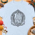 British Shorthair Club logo with cat on a light blue t-shirt.