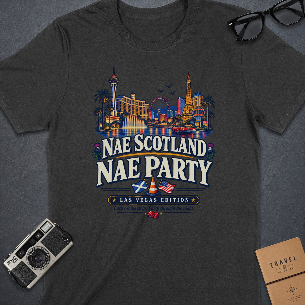 Dark grey t-shirt with Las Vegas skyline graphic and "Nae Scotland Nae Party" text.