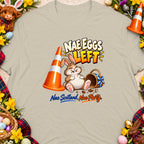 T-shirt graphic with cartoon rabbit, traffic cone, and text "NAE EGGS LEFT".