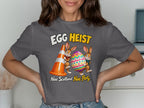 T-shirt with "Egg Heist" text and cartoon bunnies holding an Easter egg and cone.