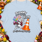 Bunny on the run illustration with Easter eggs, a traffic cone, and text.