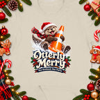 Christmas t-shirt graphic of an otter wearing a Santa hat and scarf holding a traffic cone.
