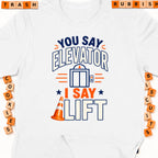 White t-shirt with "You say Elevator, I say Lift" graphic and orange traffic cone.