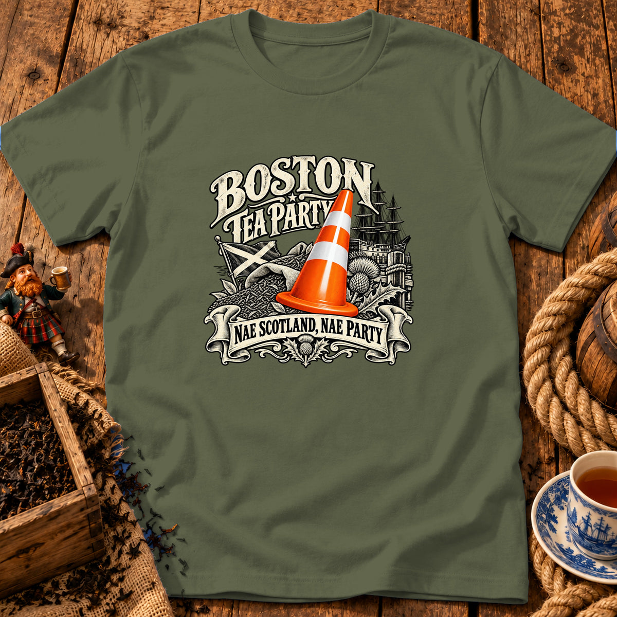 An olive green t-shirt displays graphic text reading BOSTON TEA PARTY and NAE SCOTLAND NAE PARTY with a traffic cone.