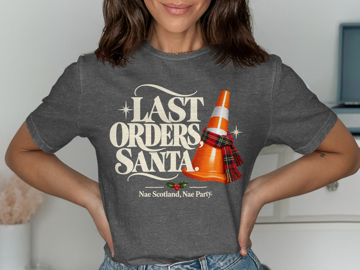 T-shirt graphic with text "LAST ORDERS, SANTA." and a traffic cone with a scarf.