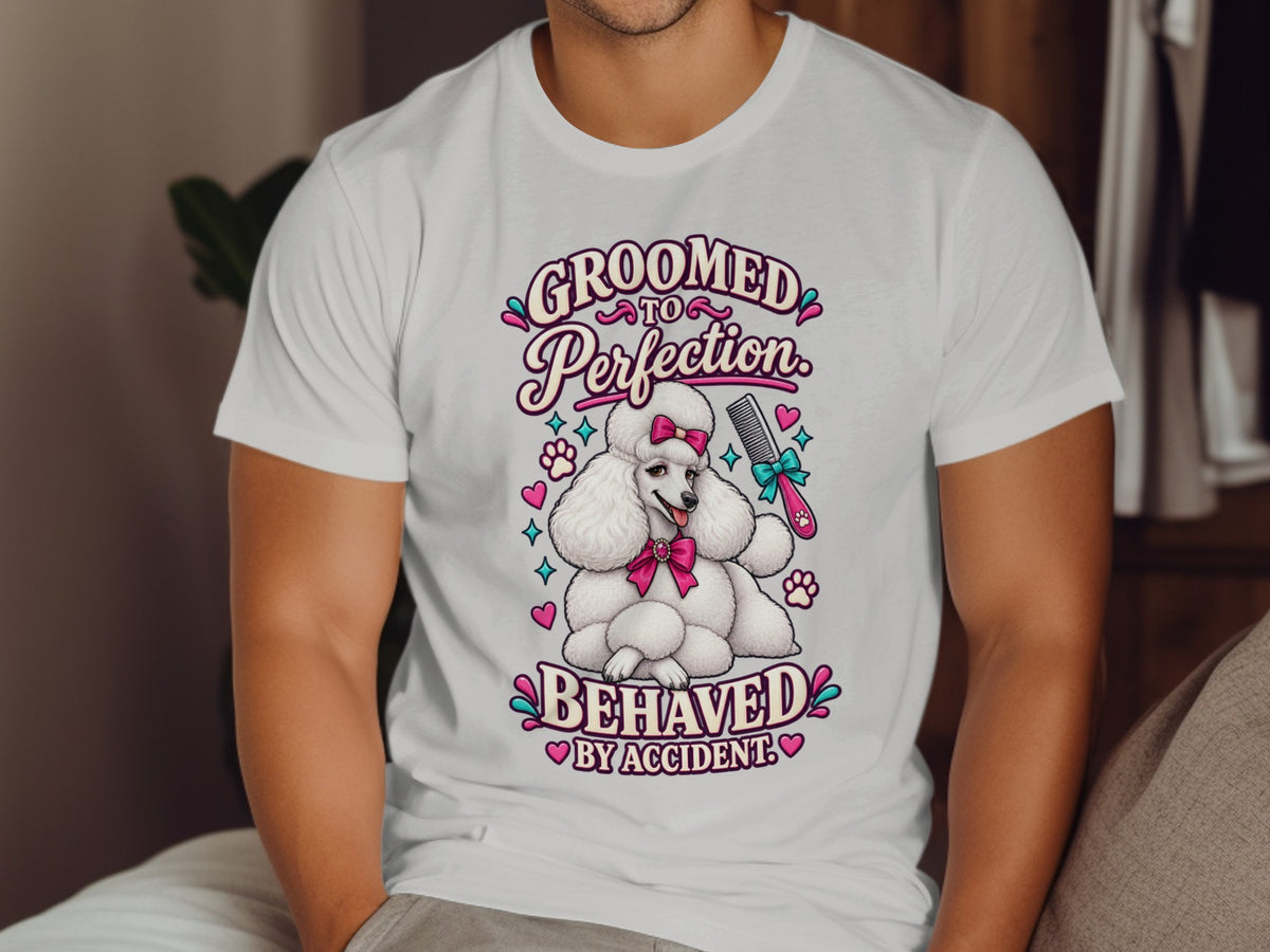 White t-shirt with a poodle graphic and text "GROOMED TO PERFECTION BEHAVED BY ACCIDENT".