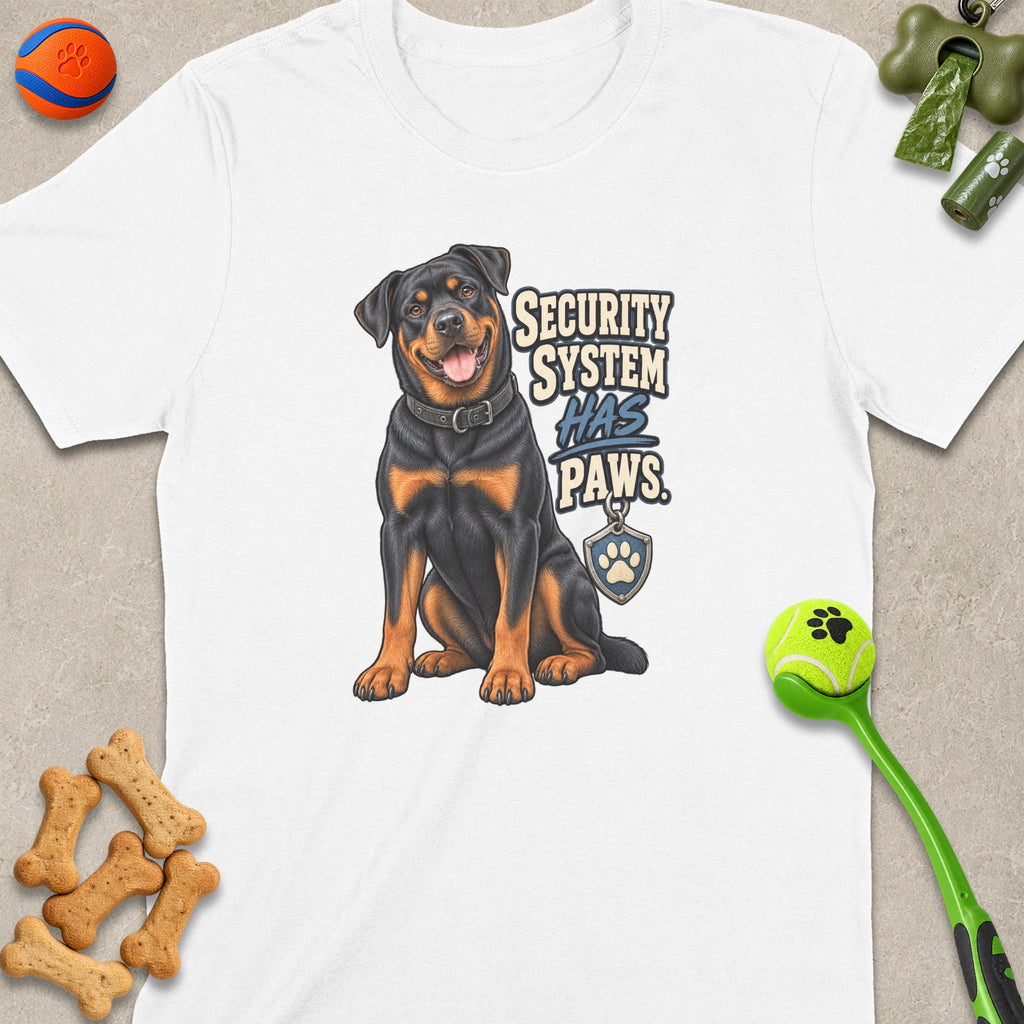 Rottweiler graphic with "SECURITY SYSTEM HAS PAWS" text on a white t-shirt.