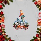 Nessie Noel graphic with cartoon monster wearing Santa hat and traffic cone, text below.