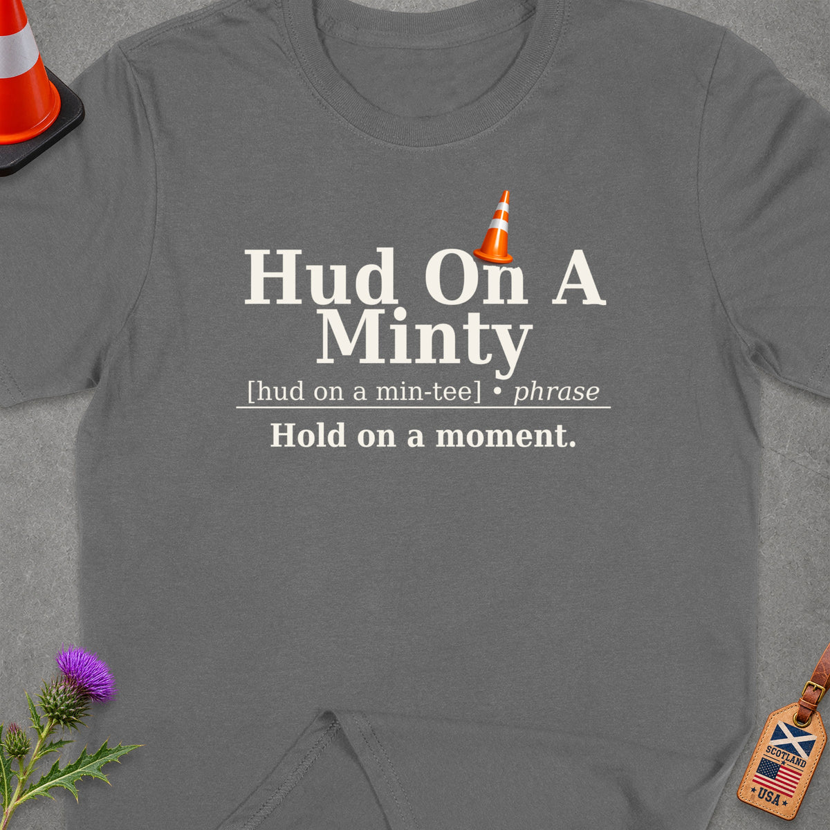Dark grey t-shirt with text "Hud On A Minty" and a traffic cone.