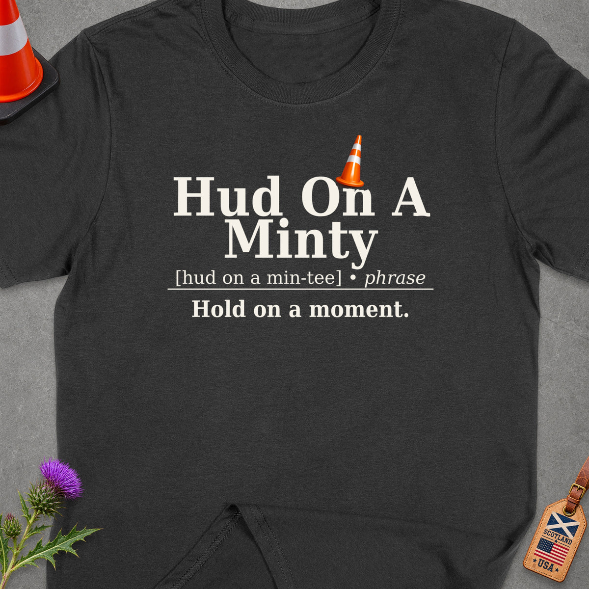 Dark t-shirt with "Hud On A Minty" text and traffic cone graphic.