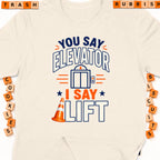 Cream t-shirt with graphic "You say Elevator, I say Lift".