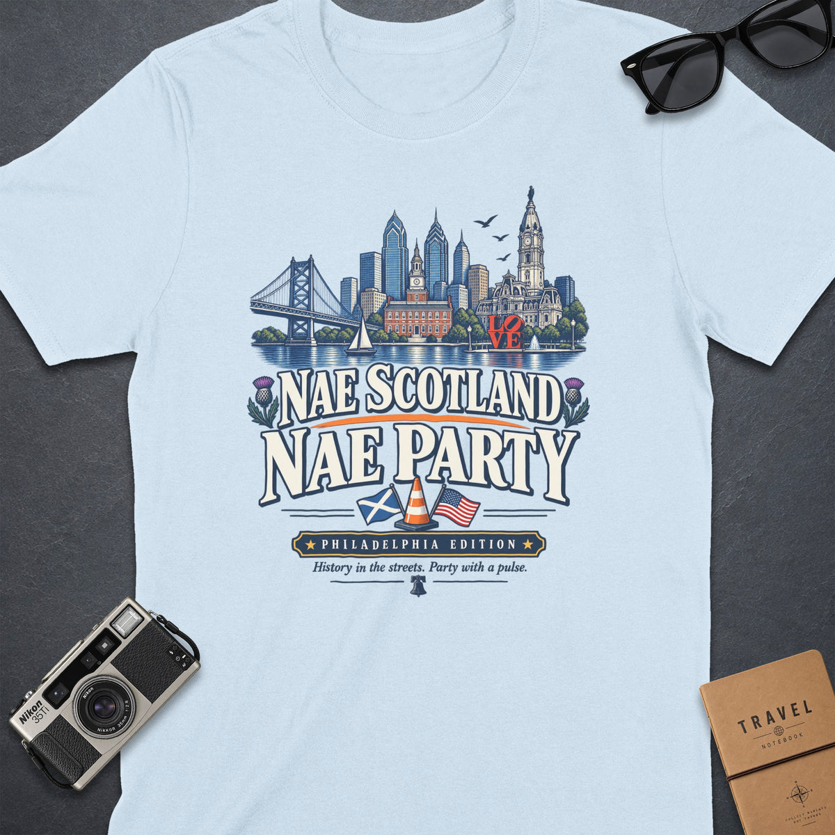 Light blue t-shirt with Philadelphia skyline graphic and "Nae Scotland Nae Party" text.