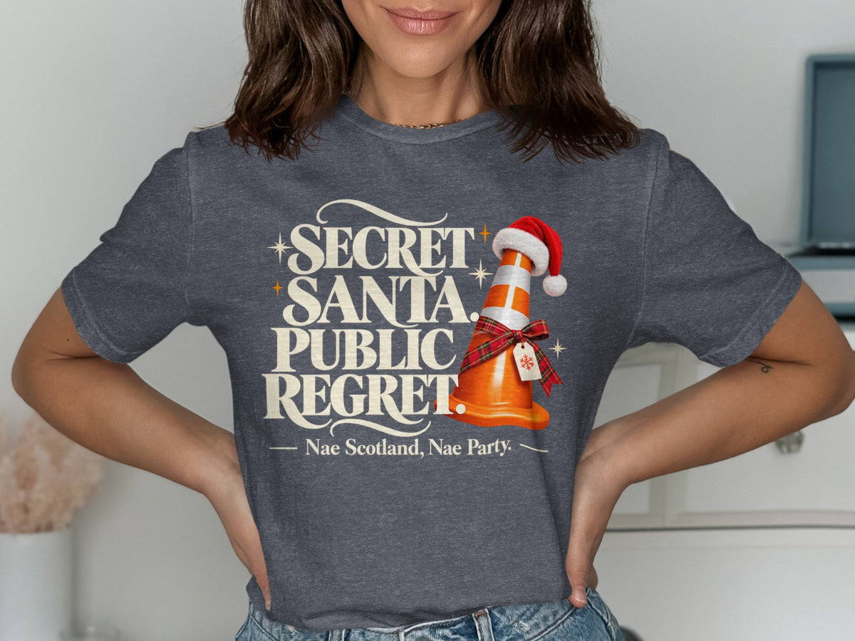 Dark grey t-shirt with "Secret Santa. Public Regret." and a traffic cone wearing a Santa hat.