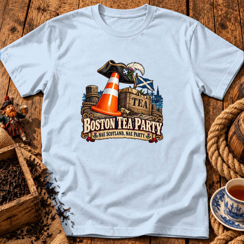 A light blue t-shirt with a graphic of a pirate hat, traffic cone, and tea crate, featuring the text "Boston Tea Party, Nae Scotland, Nae Party".