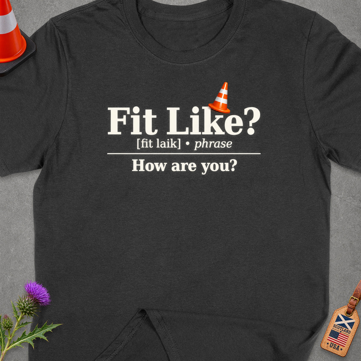 Dark t-shirt with text "Fit Like? [fit laik] phrase How are you?"