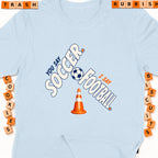 Light blue t-shirt with "You say Soccer, I say Football" text and graphics.