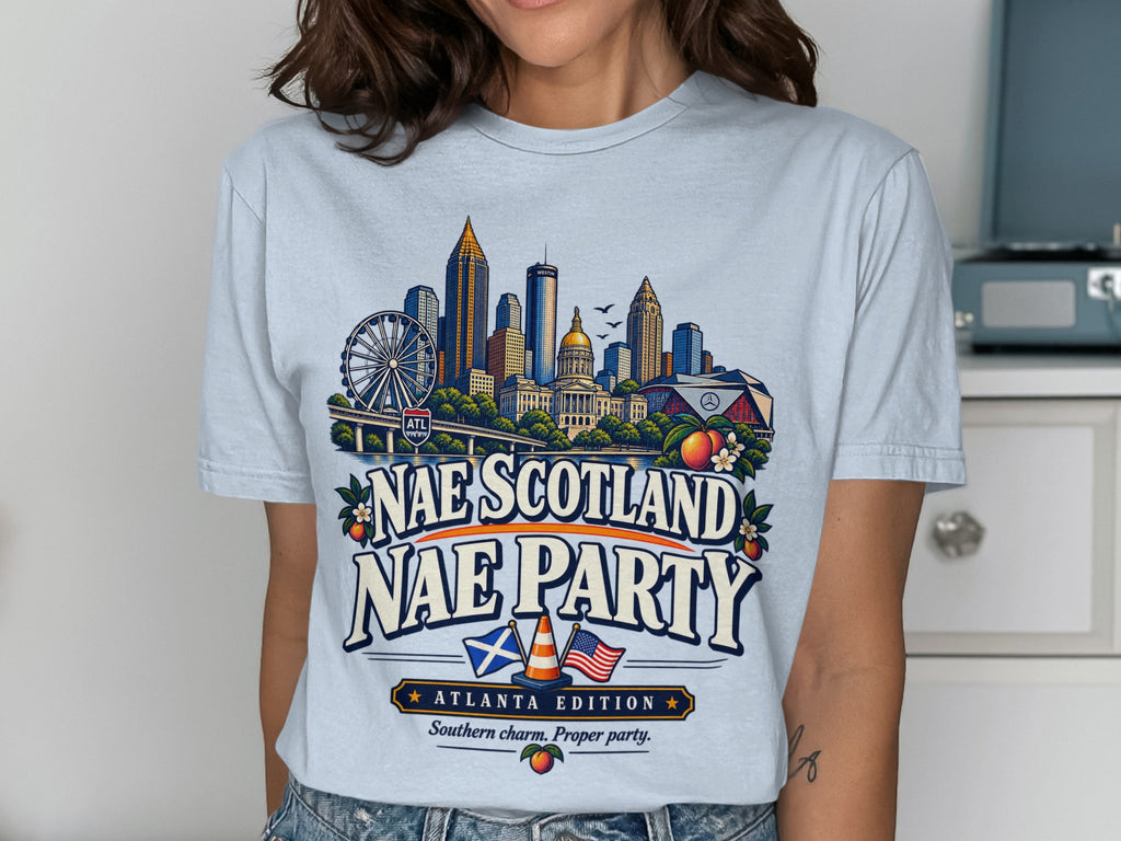 Atlanta skyline graphic on light blue t-shirt with "Nae Scotland Nae Party" text.