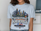 Atlanta skyline graphic on light blue t-shirt with "Nae Scotland Nae Party" text.
