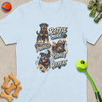 Light blue t-shirt with four Rottweiler illustrations: "Rottie Mode: Protect. Cuddle. Repeat."