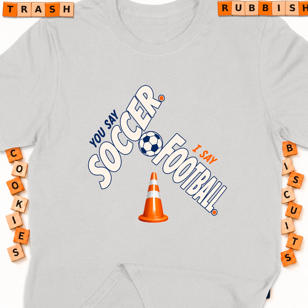 Grey t-shirt with "You say soccer, I say football" and a soccer ball.