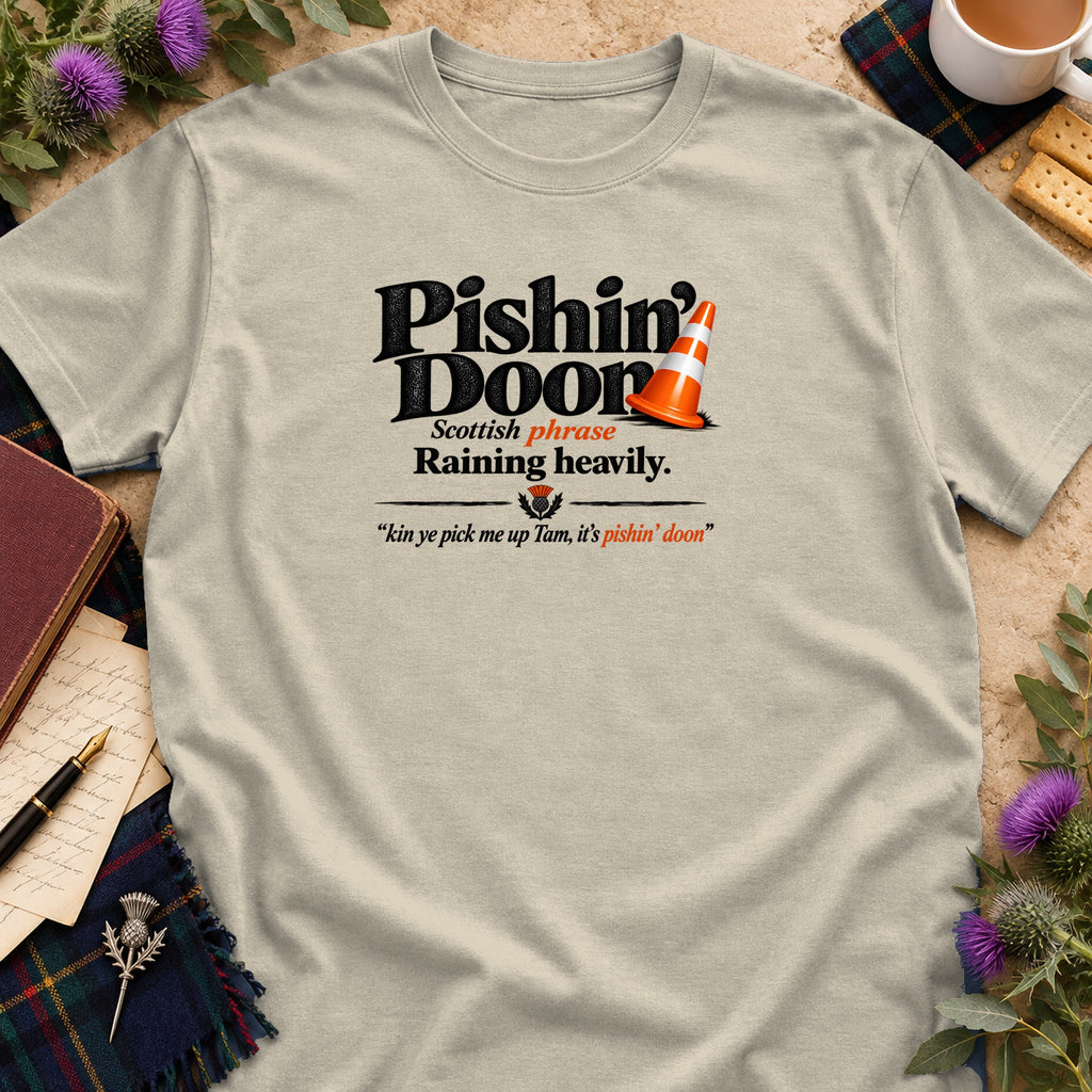A beige t-shirt printed with the Scottish phrase Pishin Doon, translating to raining heavily.
