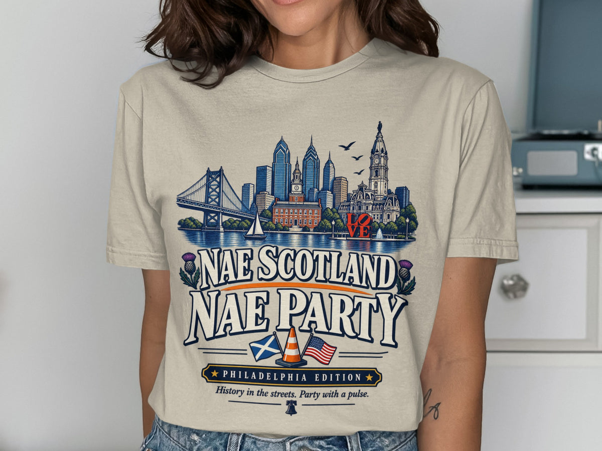 Cream t-shirt with Philadelphia skyline, "Nae Scotland Nae Party" text, and flags.