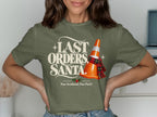 Green t-shirt with "Last Orders, Santa" and a traffic cone wearing a scarf.