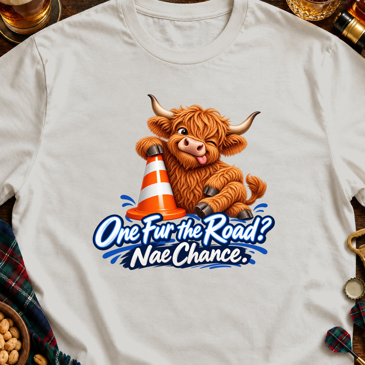 Highland cow leaning on traffic cone, text "One Fur the Road? Nae Chance."