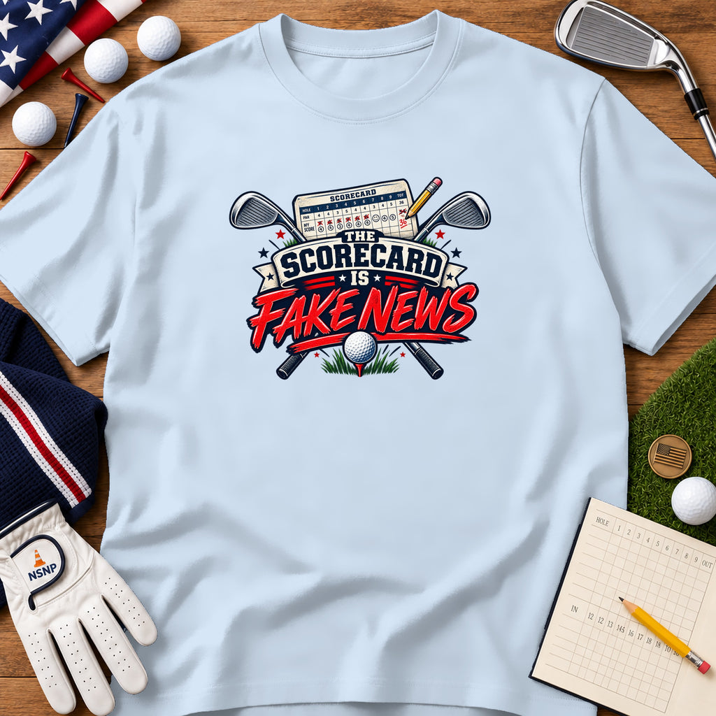 Light blue t-shirt featuring a golf graphic with crossed clubs, a scorecard, and the text The Scorecard Is Fake News.