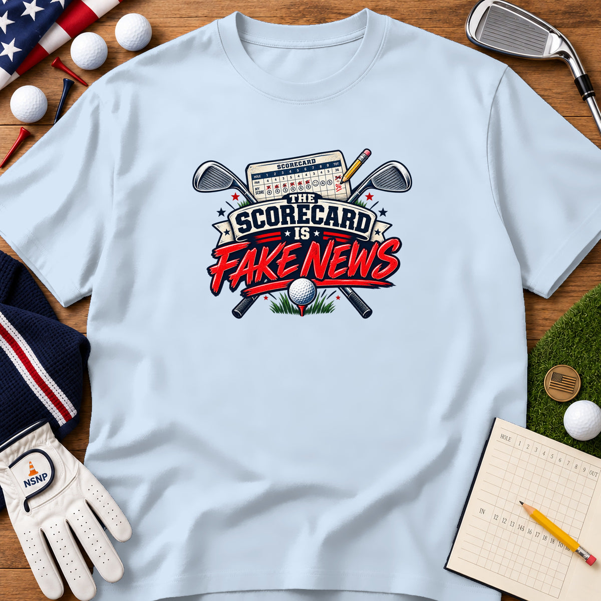 Light blue t-shirt featuring a golf graphic with crossed clubs, a scorecard, and the text The Scorecard Is Fake News.