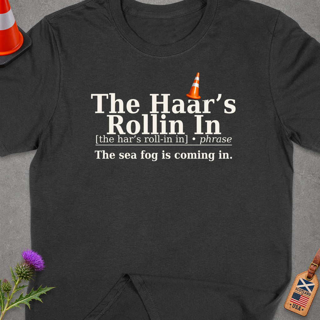 Dark t-shirt with text: "The Haar's Rollin In", "[the har's roll-in in] • phrase", and "The sea fog is coming in."