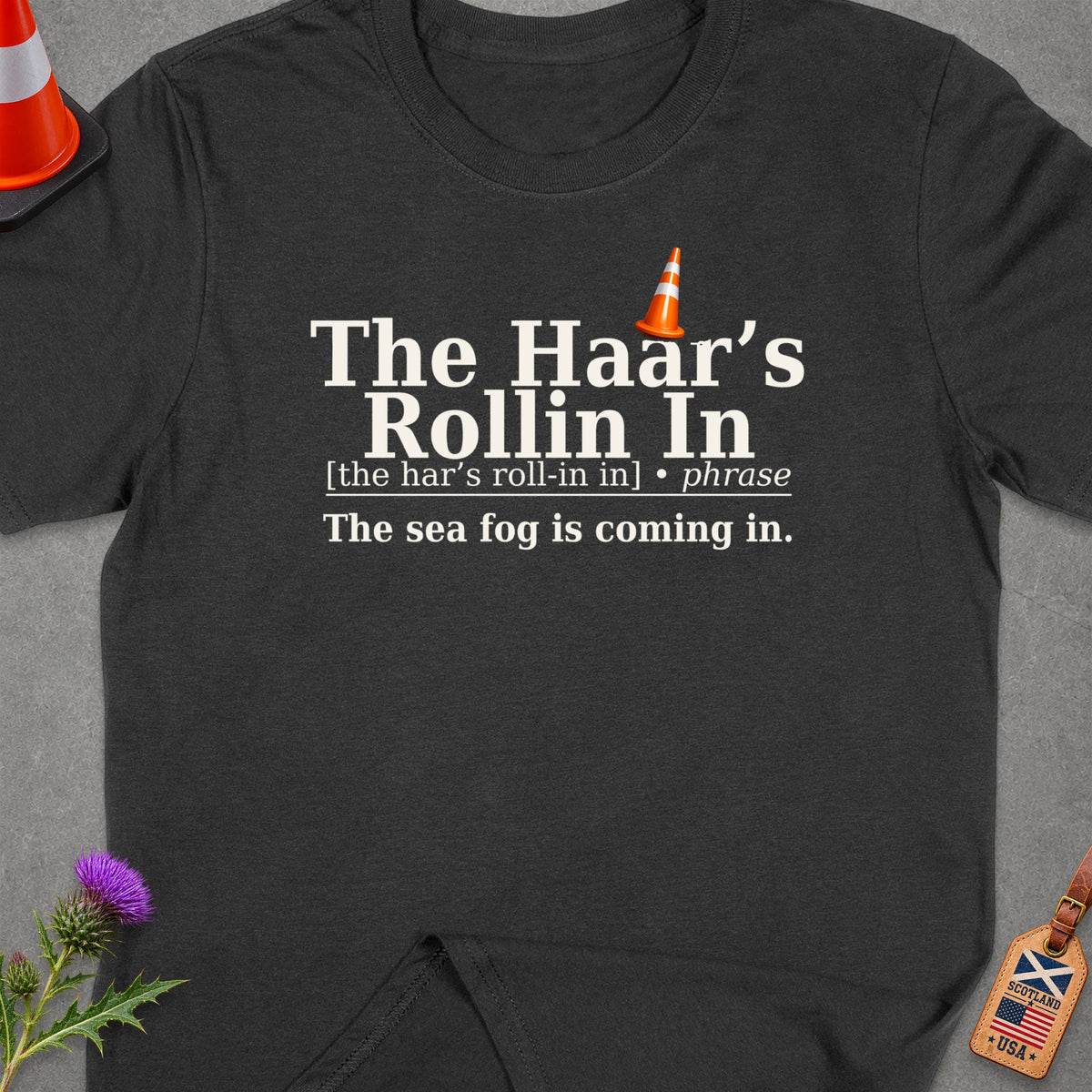 Dark t-shirt with text: "The Haar's Rollin In", "[the har's roll-in in] • phrase", and "The sea fog is coming in."