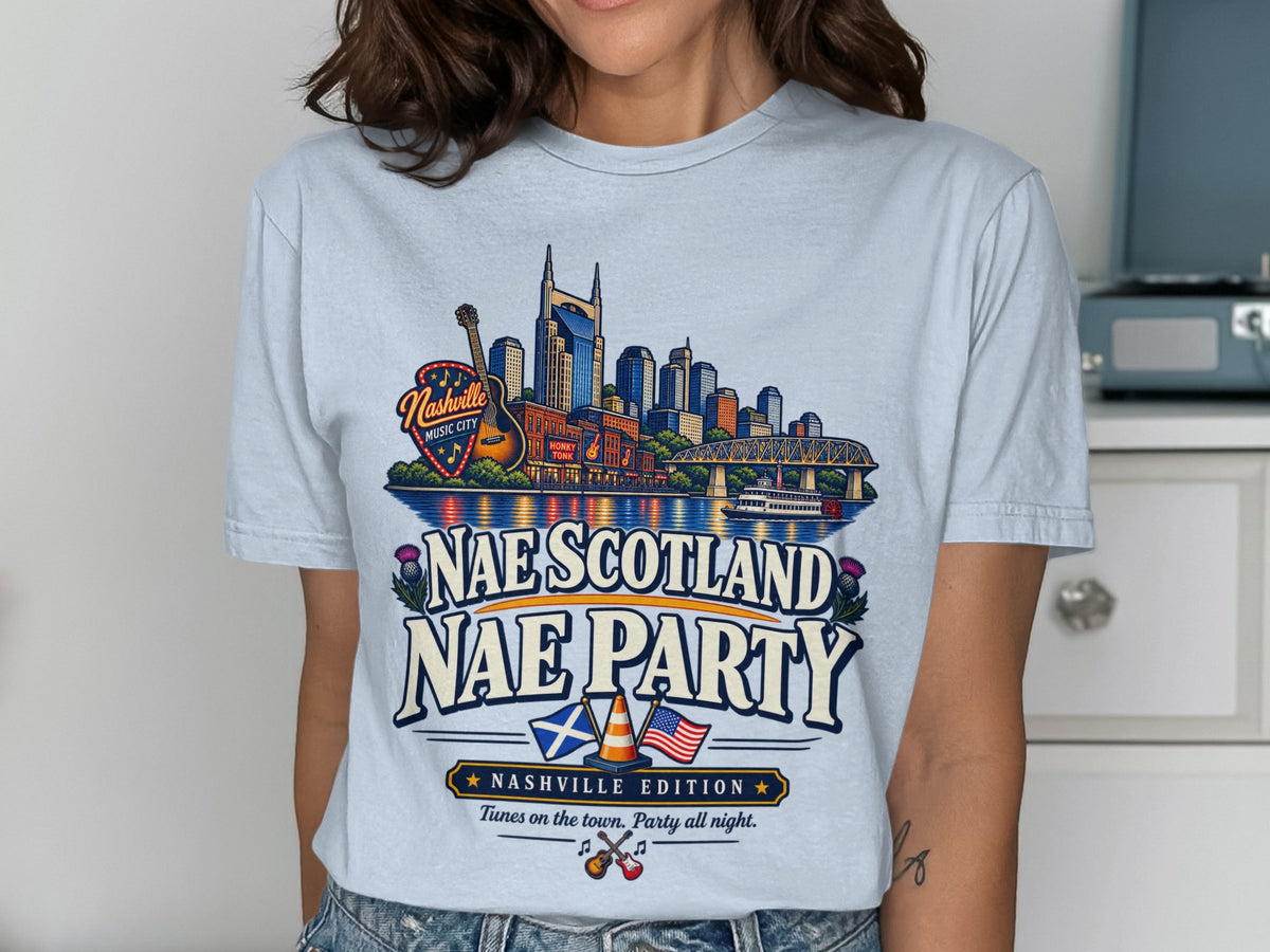 Light blue t-shirt with Nashville skyline graphic and "Nae Scotland Nae Party" text.