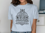 Light blue t-shirt with a black graphic of a regal Maine Coon cat wearing a crown.