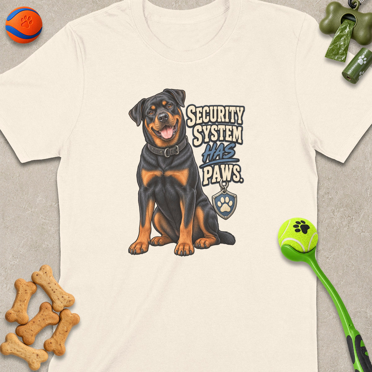 Rottweiler illustration on cream shirt with text "SECURITY SYSTEM HAS PAWS"