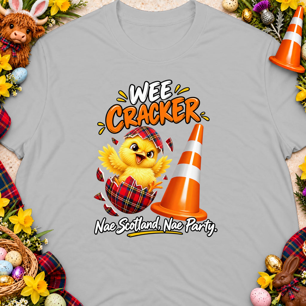 Chick hatching from a tartan egg near a traffic cone, text "Wee Cracker".