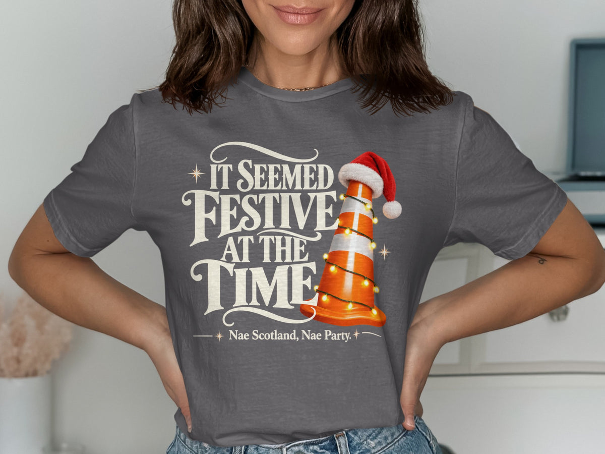 Dark gray t-shirt with "IT SEEMED FESTIVE AT THE TIME" and a traffic cone.