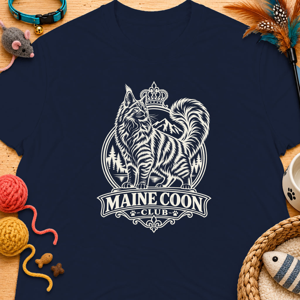 Navy t-shirt with a graphic of a Maine Coon cat wearing a crown above mountains and trees.