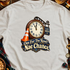 Cream t-shirt with a graphic of a clock, traffic cone, and text "Last Orders" and "One Fur The Road? Nae Chance".